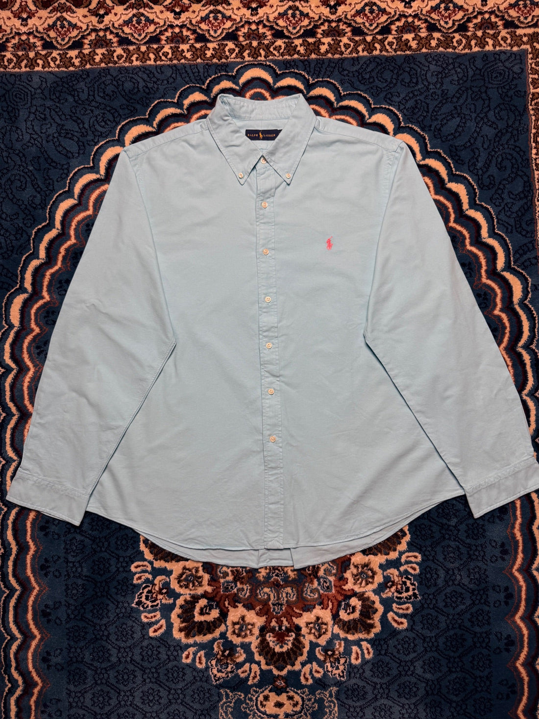 Vintage Ralph Lauren polo shirt in classic navy blue showing the embroidered pony logo