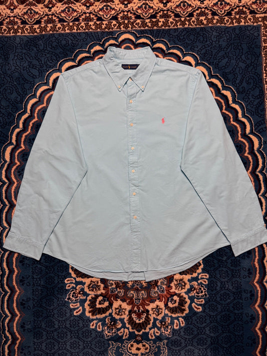 Vintage Ralph Lauren polo shirt in classic navy blue showing the embroidered pony logo