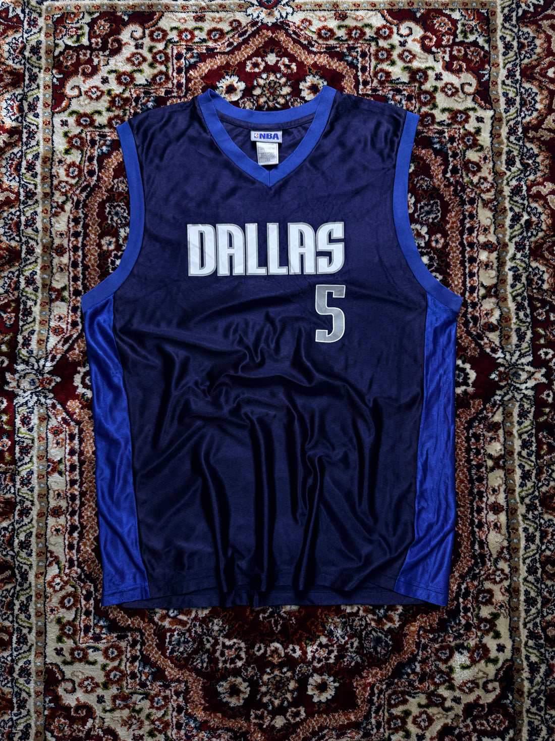 Vintage NBA basketball jersey in blue showing the stitched patch construction that identifies authentic vintage sportswear